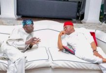 Nobody can defeat Tinubu in a free, fair election – Orji Kalu Two men wearing traditional outfits sit on a white couch, engaged in conversation in a stylish living room setting.