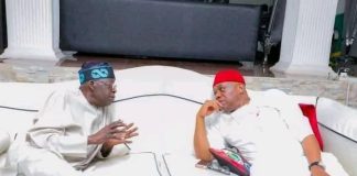 Nobody can defeat Tinubu in a free, fair election – Orji Kalu Two men wearing traditional outfits sit on a white couch, engaged in conversation in a stylish living room setting.