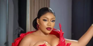 ‘Failed relationships led me to freeze my eggs’ – Ashmusy Woman in a red feathered corset posing with hand on hip during a fashion photoshoot.