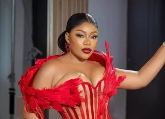 Ashmusy opens up on decision to freeze her eggs Woman in a red feathered corset posing with hand on hip during a fashion photoshoot.