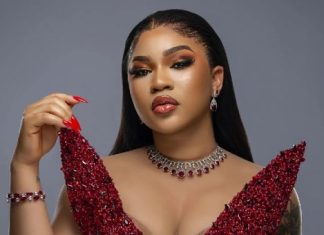 Guys are scared of successful women – Diiadem claims Glamorous woman in a red sequined gown with matching jewelry and bold makeup, looking at the camera.