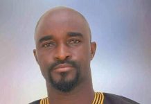 Actor Don Richard not dead amid rumours Portrait of a man with a goatee wearing a black traditional African outfit with gold embroidery, facing the camera.