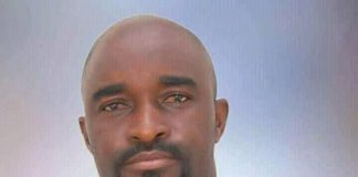 Actor Don Richard not dead amid rumours Portrait of a man with a goatee wearing a black traditional African outfit with gold embroidery, facing the camera.