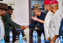 Jonathan has not endorsed my 2027 presidential ambition – Peter Obi Two men in business attire shake hands across a conference table as others look on in a formal meeting setting.