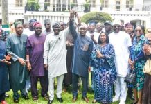 Breaking: Sanwo-Olu endorses Hamzat for 2027 Lagos governorship Group of men and women in colorful traditional outfits posing for a group photo outdoors, with one man in the center raising his hand in celebration.
