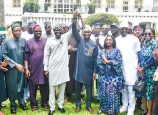 Breaking: Sanwo-Olu endorses Hamzat for 2027 Lagos governorship Group of men and women in colorful traditional outfits posing for a group photo outdoors, with one man in the center raising his hand in celebration.