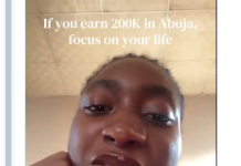 Don’t Even Think of Marriage if You Earn 200k – Lady’s Statement Sparks Debate Amid Economic Struggles (Video) Close-up of a woman talking to the camera with a motivational text overlay: 'If you earn 200K in Abuja, focus on your life'.