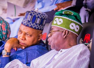 ‘They said I wanted to kill President Tinubu’ – VP Shettima Two men wearing traditional caps sit closely, one resting his chin on his hand in thoughtful conversation beside a white-clad elder in a green-patterned hat.