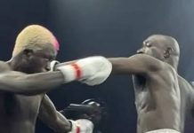 N1.3bn fight night: Carter Efe, Portable deliver big impact (Total Breakdown) Two shirtless male boxers sparring in a ring; the left boxer lands a punch to the opponent's head, both wearing white gloves with red trim.