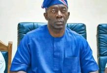 2027: Makinde backs Adekambi as preferred successor Man in a blue traditional outfit and headwrap seated in a conference room, facing the camera.