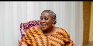 “I was shocked some films got no nominations” – Joke Silva opens up on AMVCA selection process A smiling woman in a colorful zigzag dress sits on a patterned chair, gesturing with open hands as she speaks.