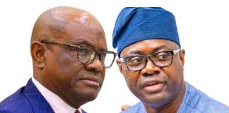 Wike dismisses PDP-APM alliance, says Makinde’s presidential ambition ‘dead on arrival’ Two men in conversation, one in a blue suit and red tie, the other in a blue traditional cap and attire, against a white background.