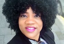 Opeyemi Aiyeola calls for public outcry after abduction in Oyo Close-up portrait of a smiling woman with tight curly hair outdoors and a black jacket.