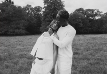 Mr Eazi, Otedola’s daughter Temi expecting first child Black-and-white photo of a couple embracing in a grassy field, the man cradling the woman's head as they lean together.