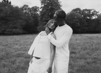 Mr Eazi, Otedola’s daughter Temi expecting first child Black-and-white photo of a couple embracing in a grassy field, the man cradling the woman's head as they lean together.