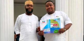 Seyi Tinubu encourages Cubana Chief Priest after APC ticket loss Two men in white traditional attire stand together; one holds a colorful 2026 nomination form booklet.