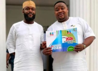 Seyi Tinubu encourages Cubana Chief Priest after APC ticket loss Two men in white traditional attire stand together; one holds a colorful 2026 nomination form booklet.