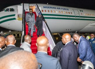 President Tinubu arrives Nairobi for Africa Forward Summit Dignitaries step down from a Nigerian Air Force jet onto a red-carpeted stairs at night, surrounded by officials on tarmac.