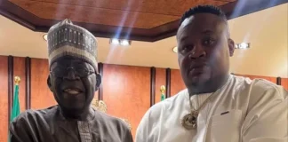 2027: ‘Tinubu doesn’t trust me as an Igbo man’ – Cubana Chief Priest Two men in traditional Nigerian attire shake hands in a formal room, with flags in the background. One wears a dark brown kaftan and cap, the other a white tunic with a gold chain.