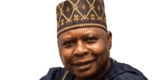 BREAKING: Makinde-led PDP appoints Turaki as interim national chairman Smiling man in a patterned cap and dark traditional attire against a white background, portrait.