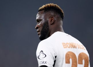 Boniface Reveals Why He Wears No. 22 Footballer in a white jersey, back visible with number 22 and name BONIFACE, facing left on the field.