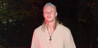 Haaland to make acting debut as Viking in animated film Person in medieval cosplay stands outdoors at night, wearing a beige tunic, leather bracers, belt, and holding a round shield with a cross emblem